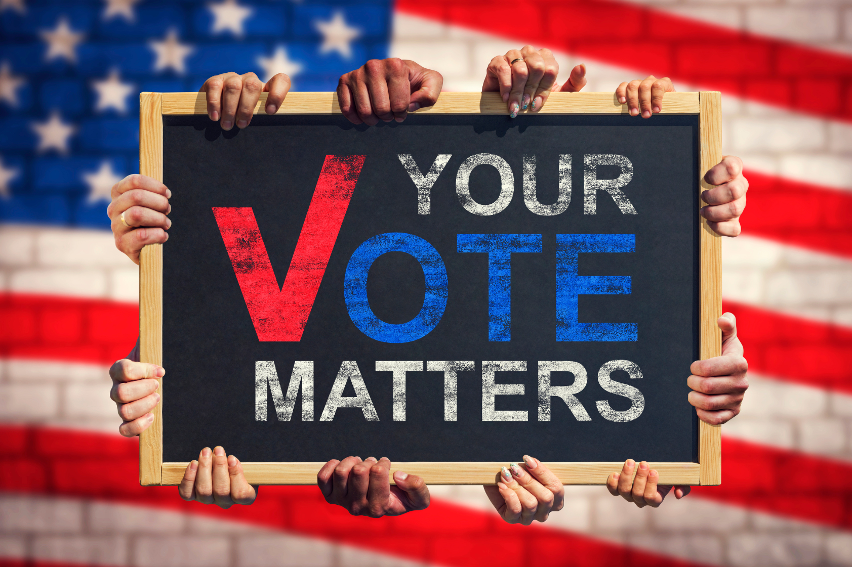 text: Your Vote Matter image: an american flag background with a chalkboard held up by many hands with the words